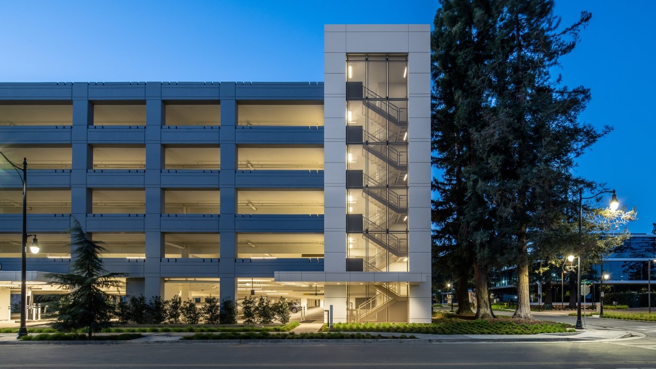 Exterior view of parking garage at night.