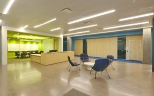 Glass enclosed conference room and small group seating area.