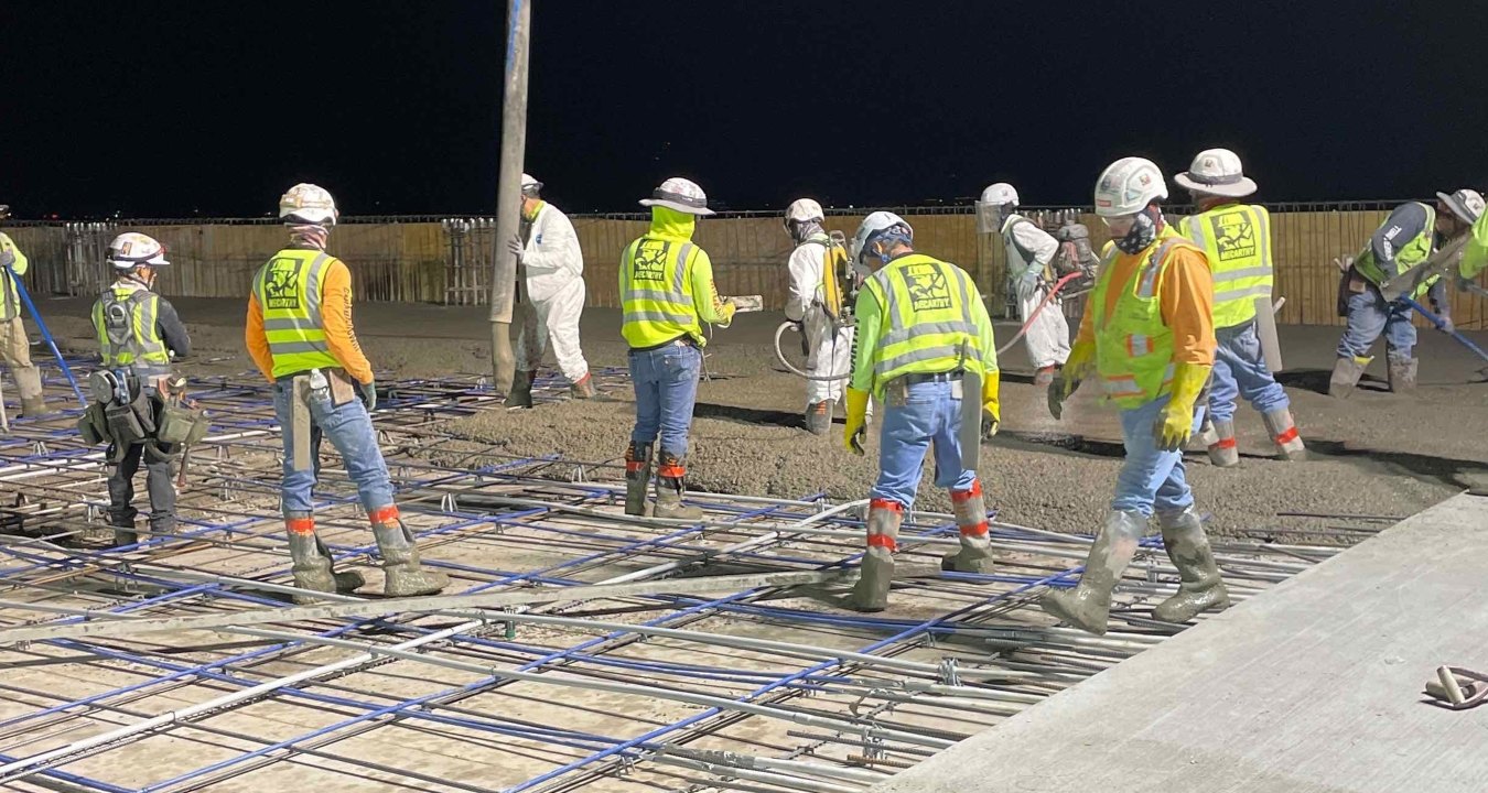 construction workers pouring concrete