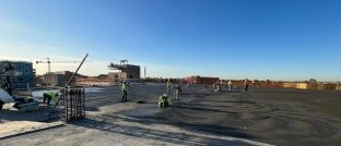 construction workers pouring concrete