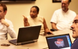 People having a meeting in a conference room.