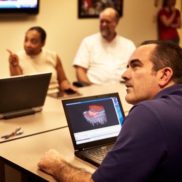 People having a meeting in a conference room.