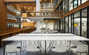 A table with four chairs overlooking a common area.