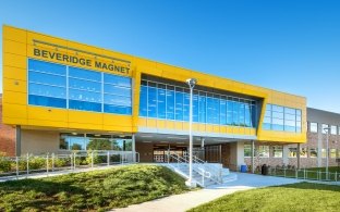 The front entrance Beveridge Magnet Middle School with a large yellow upper floor.