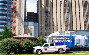 mccarthy truck on lawn by a building.