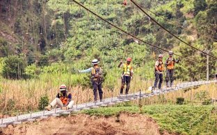 Group of people working on constructing a bridge