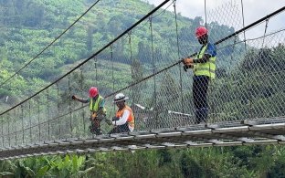 Three people working on bridge construction