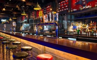 A bar area with high top chairs