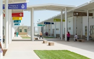 Courtyard at Housing and Healthcare Facility Stockton with People Walking Around