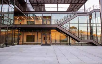 A staircase and large glass windows on the exterior of a building.