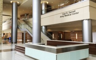 A front desk area with a staircase to the left of the desk