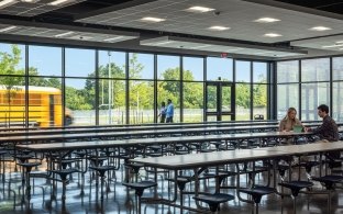 Two people sitting in the school's cafeteria