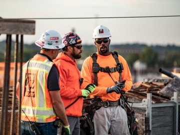 People on jobsite talking. 