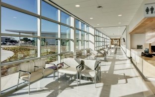 An open area with large glass windows and lounge chairs