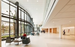 An open area with large glass windows and lounge chairs