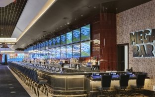 A large bar area with a long bartop and high-top chairs.