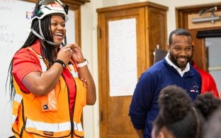 a construction worker speaking to students