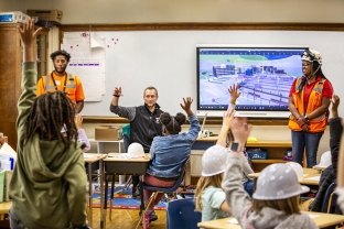 volunteers in front of classroom