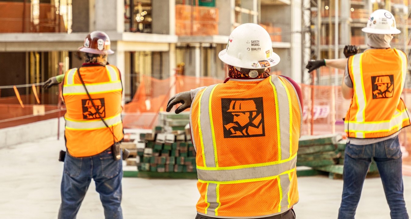 Construction workers stretching on the jobsite.