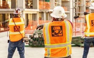 Construction workers stretching on the jobsite.