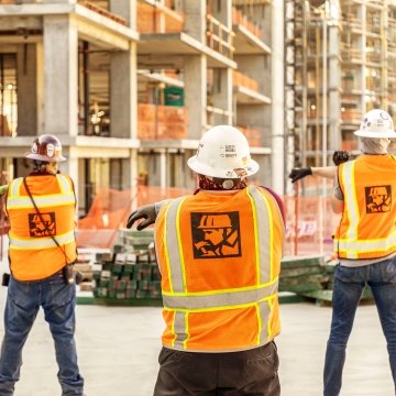 Construction workers stretching on the jobsite.