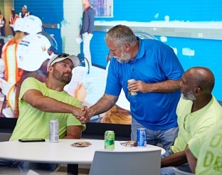 Three people shaking hands. 