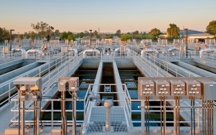 Several rows of water treatment plant pools and tanks.