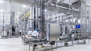 Indoor image of workers working at a station 