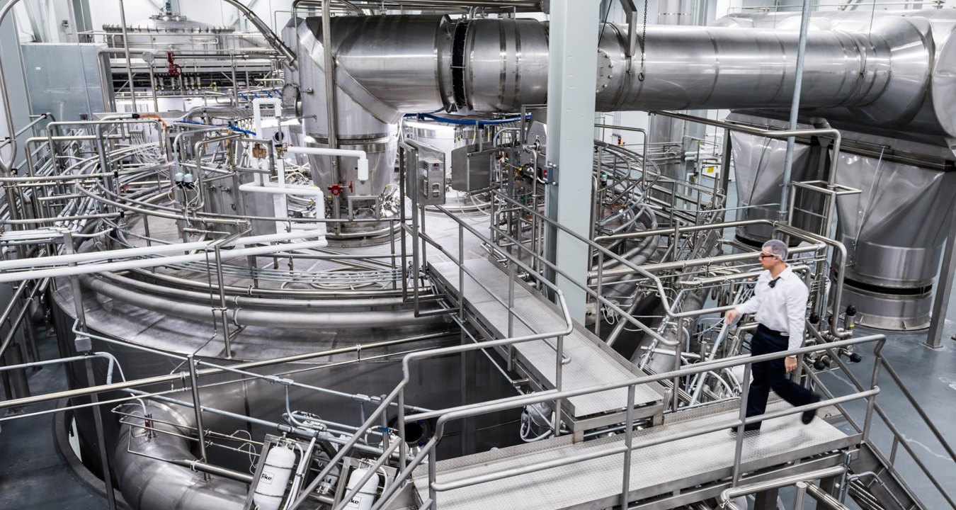 Person walking in industrial facility. 