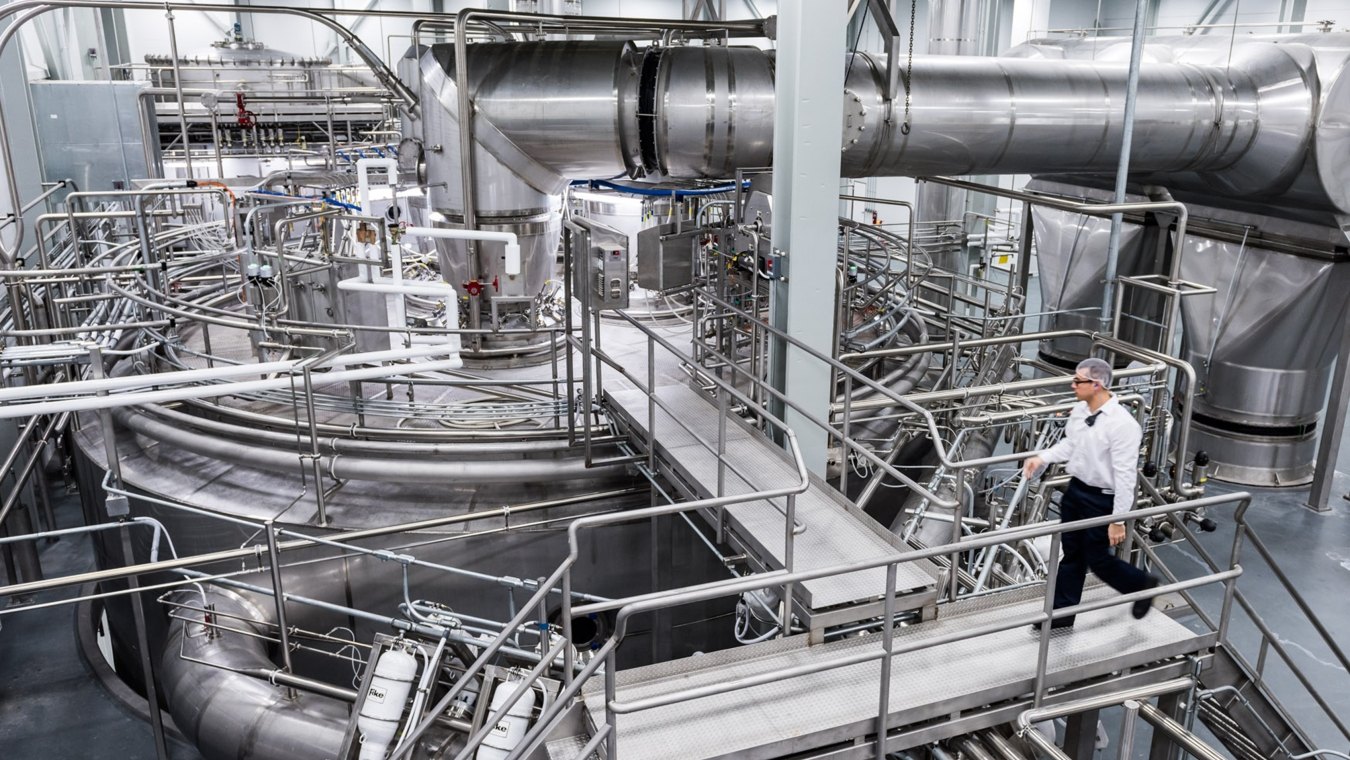 Person walking in industrial facility. 