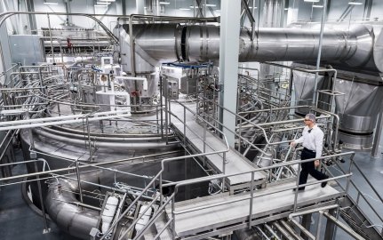 Person walking in industrial facility. 