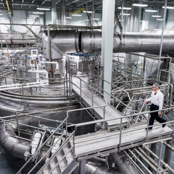 Person walking in industrial facility. 