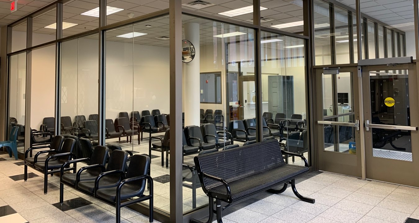 Interior view of a waiting room with chairs.