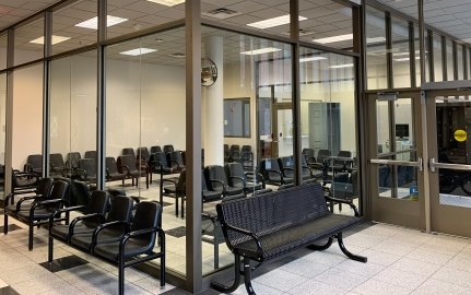 Interior view of a waiting room with chairs.