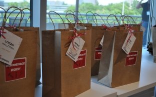 Paper bags with stickers reading "Welcome Back"