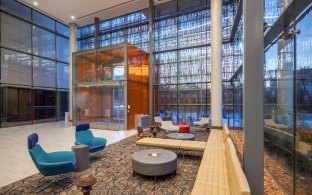 A sitting area surrounded by large glass windows.