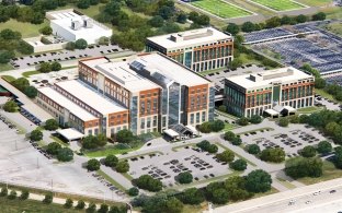 Aerial rendering of the campus showing multiple buildings and parking lot