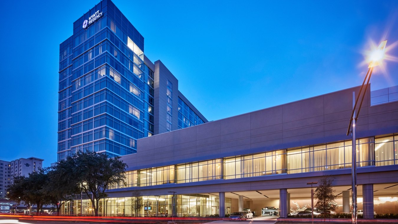 Outdoor image of the hotel with a medium blue sky