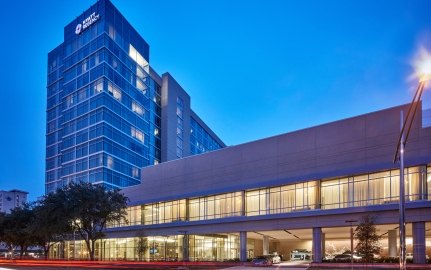 Outdoor image of the hotel with a medium blue sky