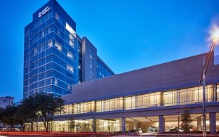 Outdoor image of the hotel with a medium blue sky