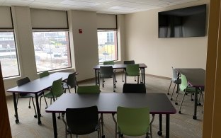 View of a room with tables and chairs.