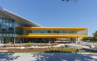 Side of the building with landscaping and a blue sky