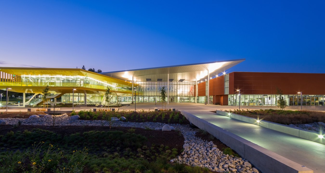 Entrance to the college building at dusk with a dark blue sky