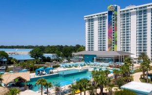 Exterior view of the resort tower with the pool in the foreground 