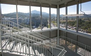 A staircase and large glass windows.