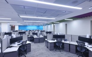 Mayo Clinic office cubicles with multiple desks, chairs and computers