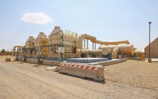 Ground-level view of the piping system at a water facility.