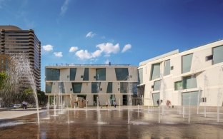 Outdoor image of water fountains shooting from the concrete