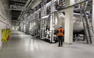 Person standing next to decontamination tanks