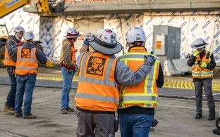 Employee giving pat on the back to another employee